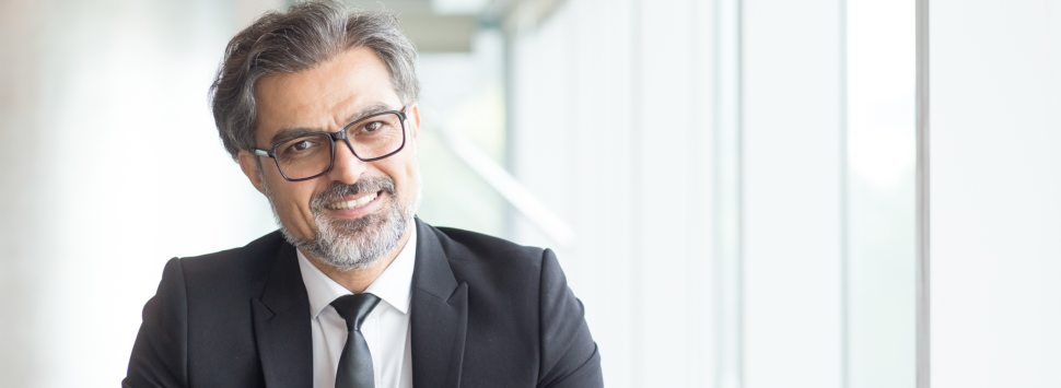 Cheerful businessman in eyeglasses in office